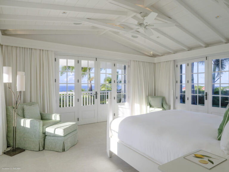 Bright bedroom with French doors and ocean view at Villa Antares, St. Barts.