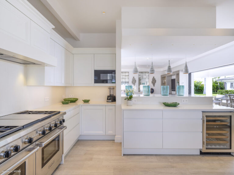 Modern white kitchen with open layout at Villa Antares, St. Barts.