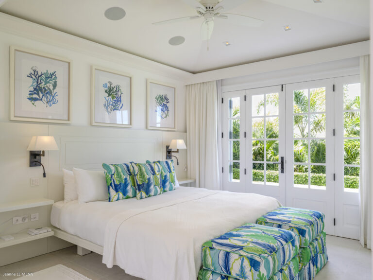 Elegant bedroom with tropical accents and French doors at Villa Antares, St. Barts.