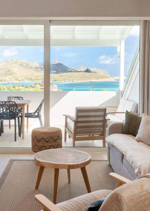 Lounge area with balcony and bay view at Villa Aqua, St. Barts.