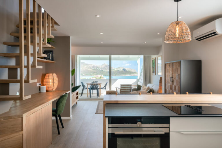 Modern open-plan kitchen and living area with sea view at Villa Aqua, St. Barts.