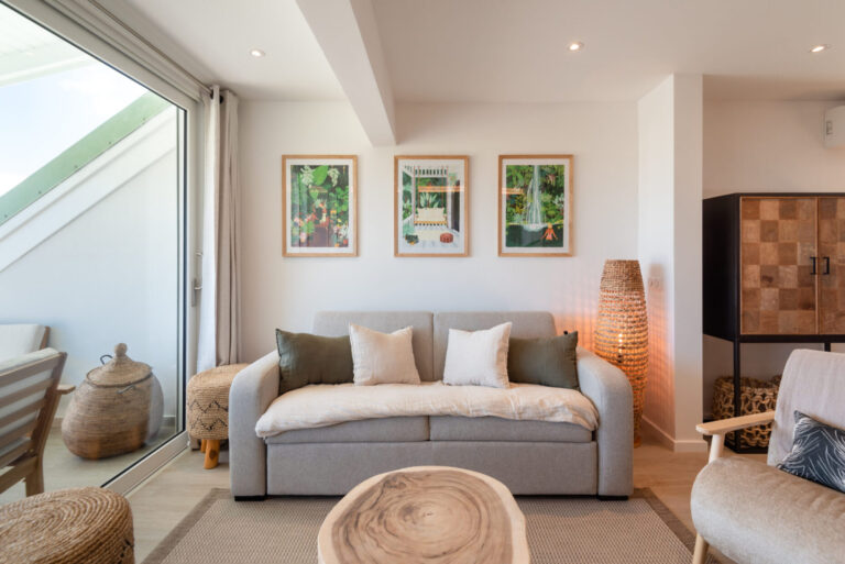 Stylish lounge seating area with balcony access at Villa Aqua, St. Barts.