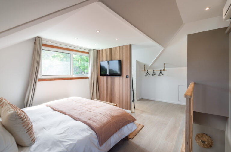 Bright loft-style bedroom with TV at Villa Aqua, St. Barts.