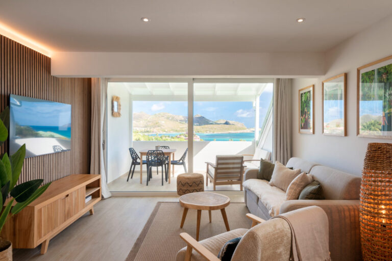 Cozy living room with balcony and ocean view at Villa Aqua, St. Barts.