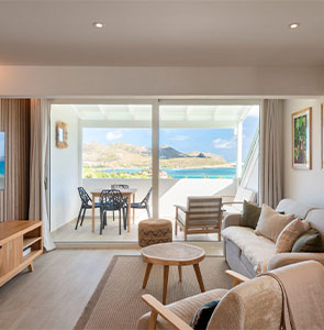 Living room opening to balcony with sea view at Villa Aqua, St. Barts.