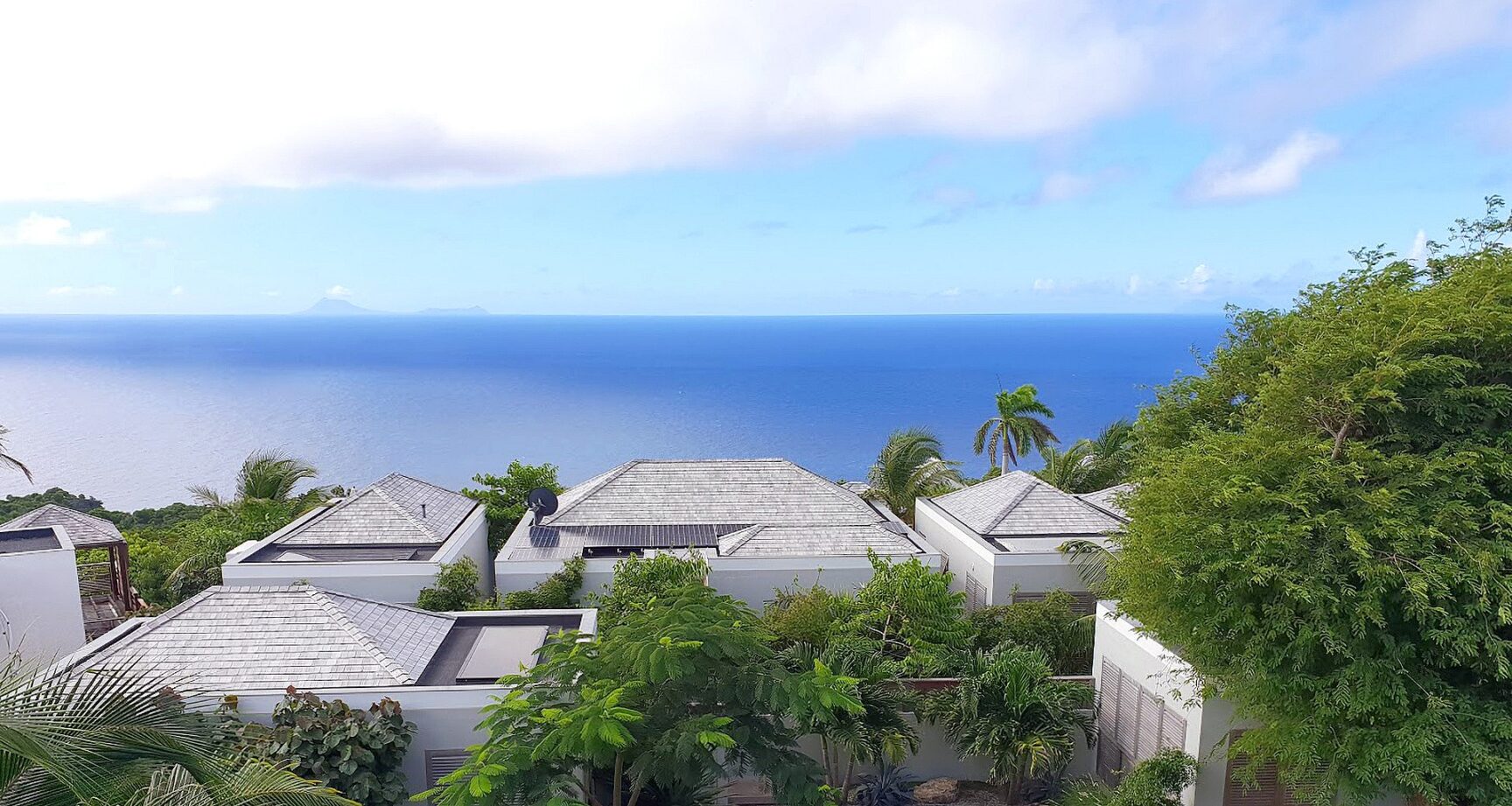 Hillside villa rooftops with sweeping ocean view at Villa Caro, St. Barts.