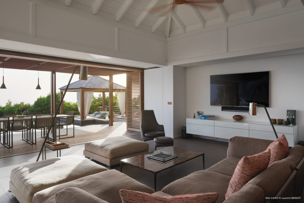 Contemporary living room opening to poolside terrace at Villa Caro, St. Barts.