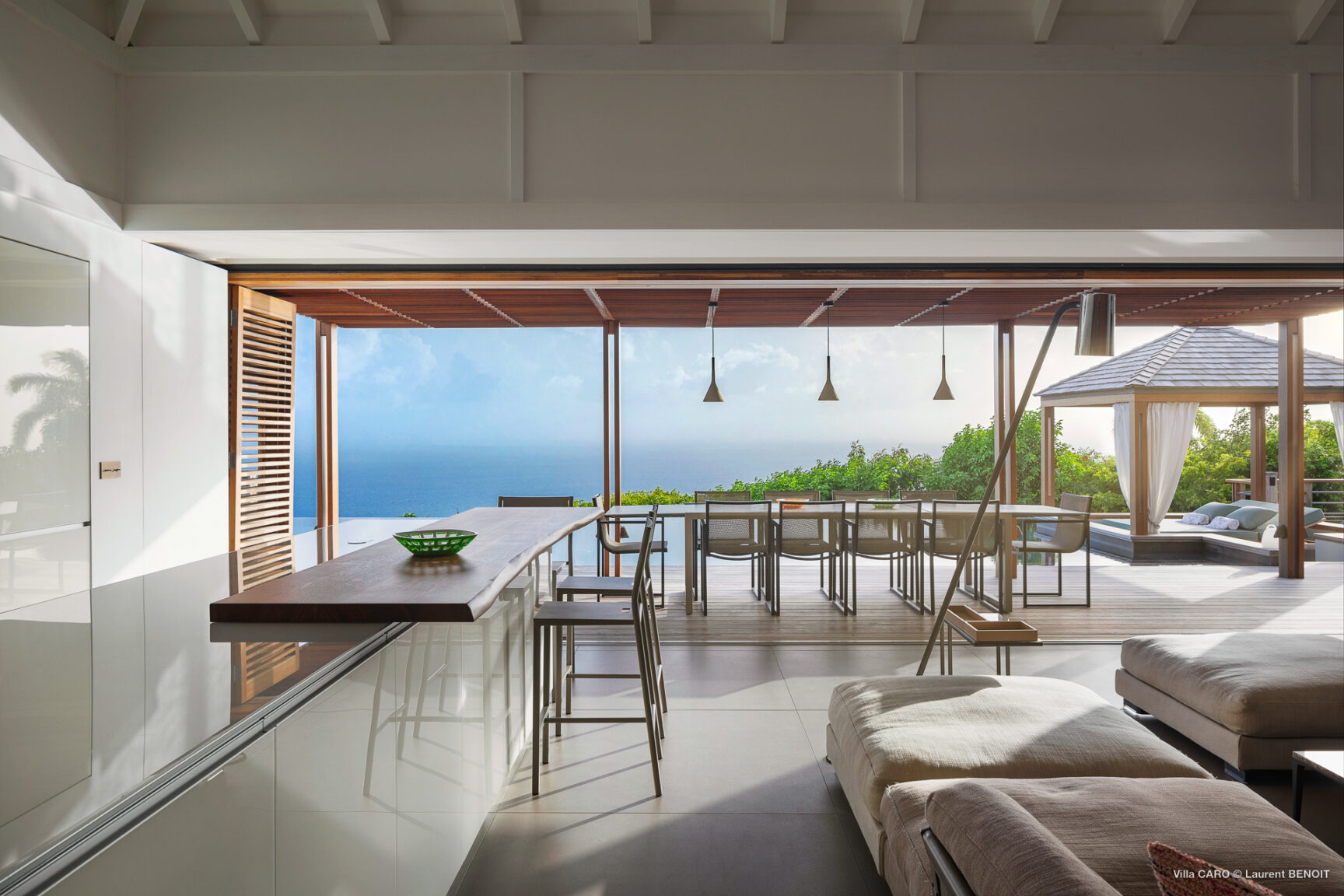 Open-concept kitchen and lounge with ocean-view terrace at Villa Caro, St. Barts.