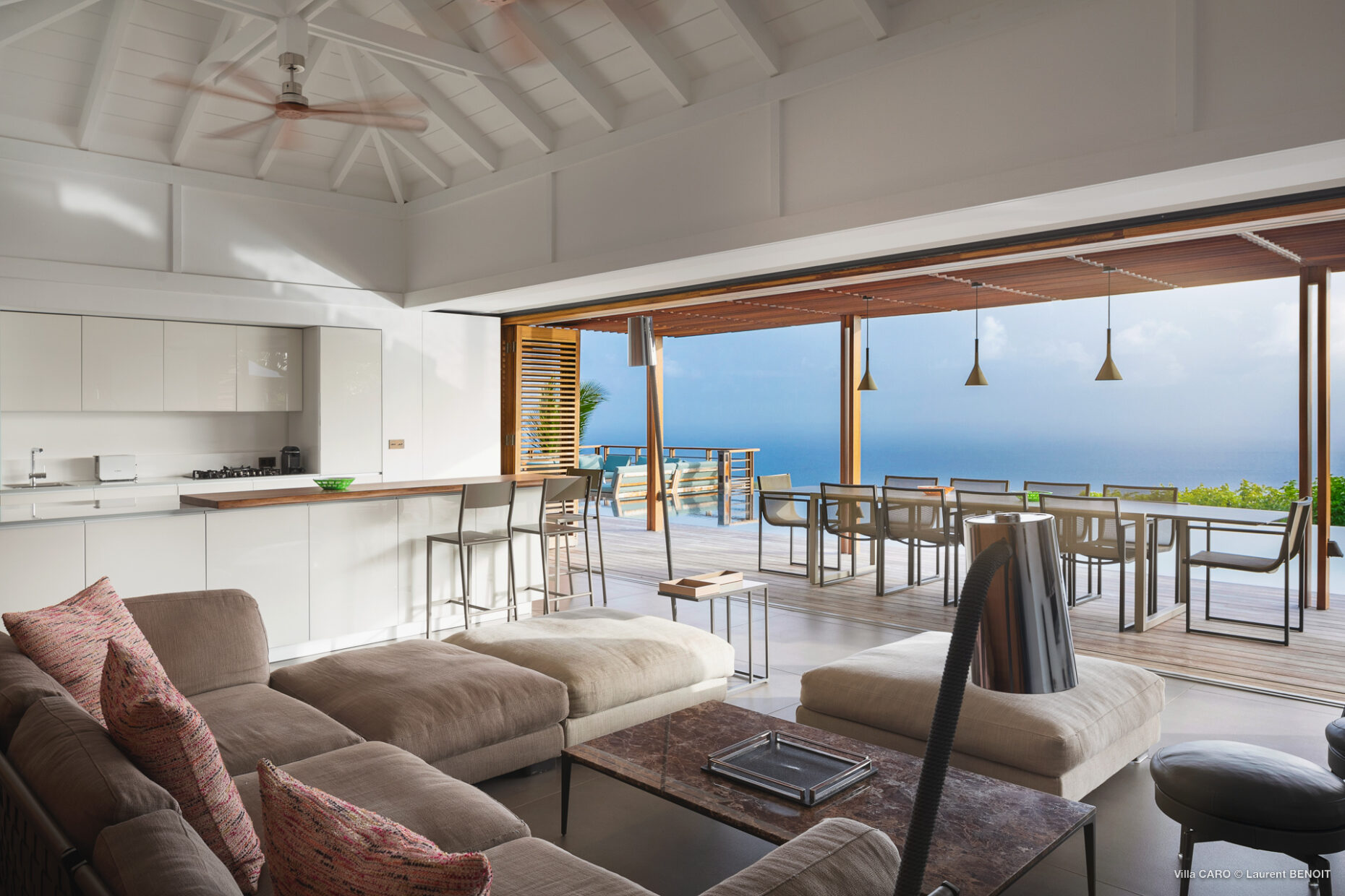 Open-plan living and dining space with ocean-view terrace at Villa Caro, St. Barts.
