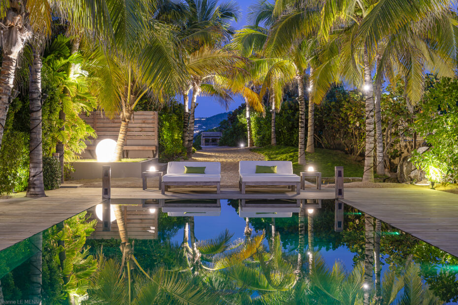 Villa K St. Barts night pool with palm reflections and loungers