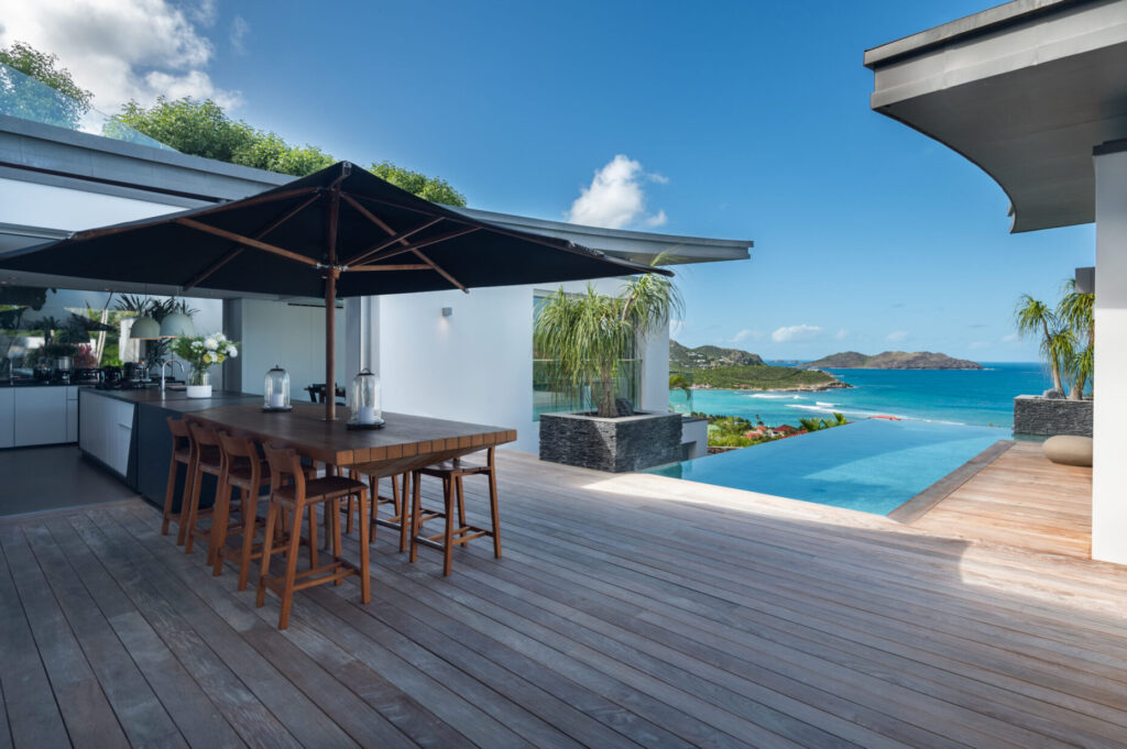 Outdoor dining terrace at Villa Wings St. Barts with infinity pool and sea view.