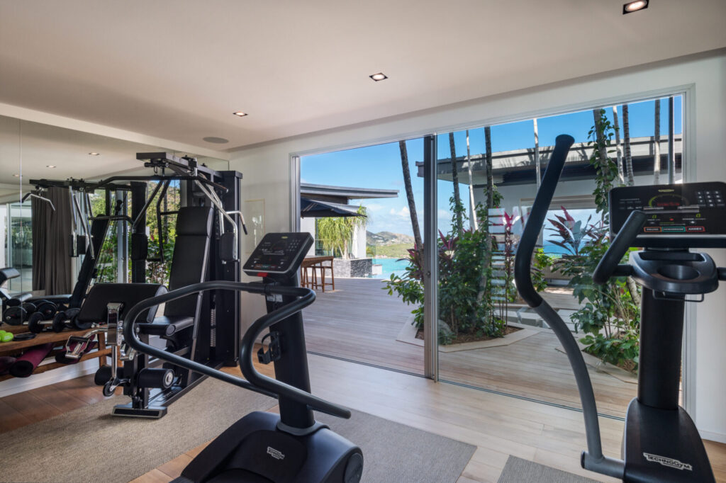 Private gym at Villa Wings St. Barts with ocean-facing terrace view.