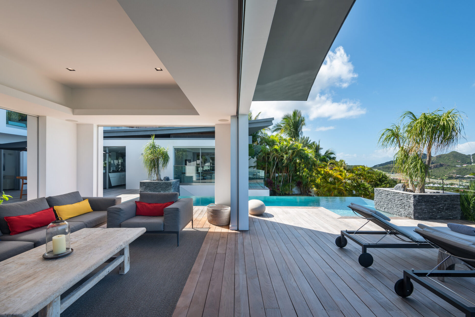 Open-plan kitchen at Villa Wings St. Barts with island and outdoor bar seating.