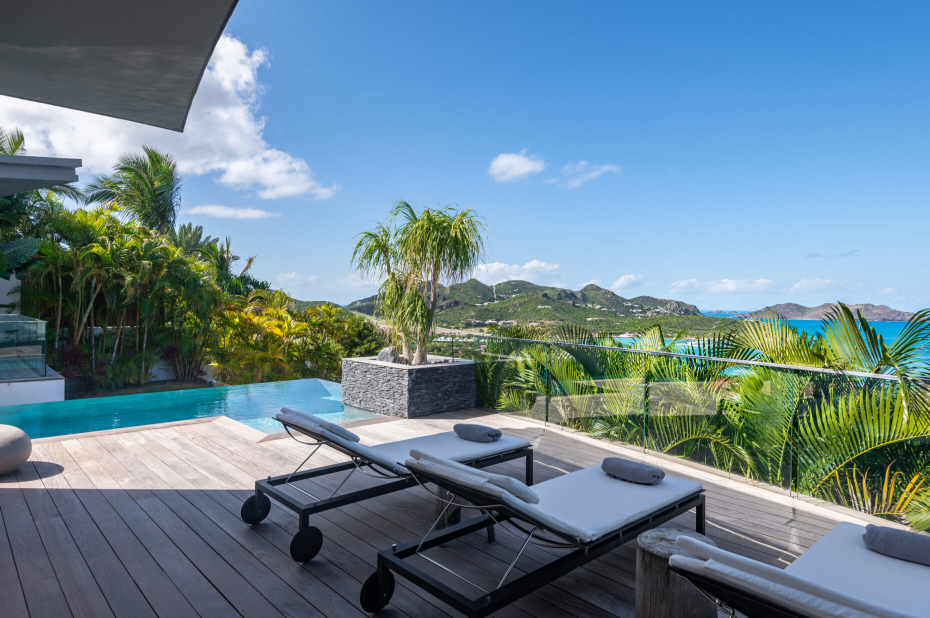 Pool terrace at Villa Wings St. Barts with lounge chairs and ocean views.